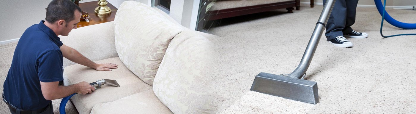 Professional cleaner using steam cleaning equipment on carpet and upholstery in residential setting, emphasizing carpet maintenance and hygiene.