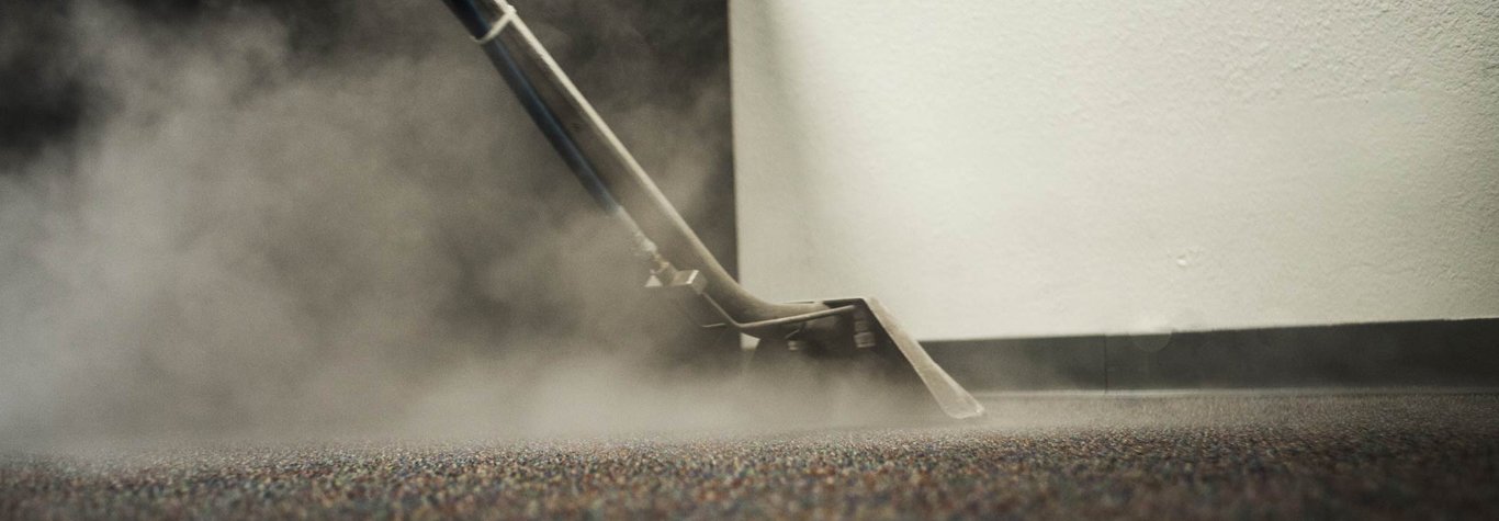 Steam cleaning process on carpet, showcasing steam extraction equipment and visible steam, emphasizing professional carpet cleaning services in Melbourne.